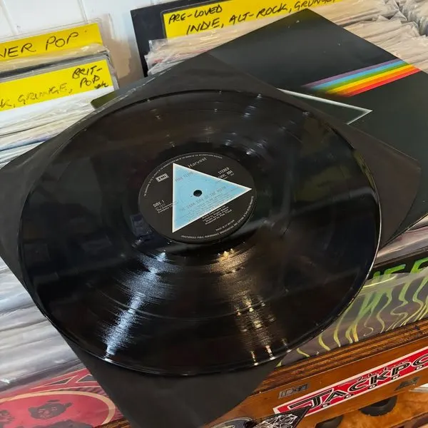 A Pink Floyd record laid out over the shop's vinyl racks and handwritten dividers.