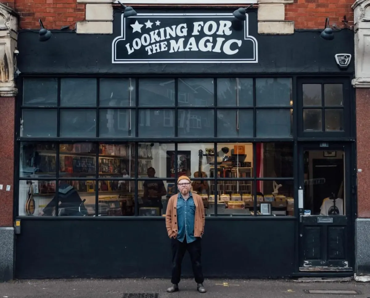 The black painted shopfront of Looking For The Magic Records, with its hand-painted sign above the window.